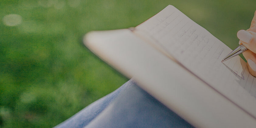 Woman writing in notebook Meeting minutes